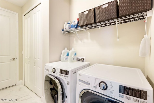 laundry area featuring washing machine and clothes dryer