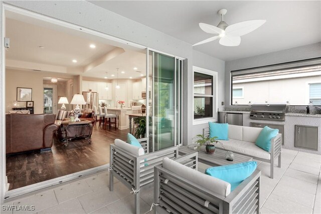 interior space with plenty of natural light, sink, and ceiling fan