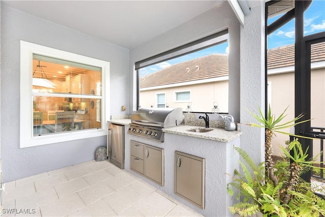 view of patio featuring area for grilling, sink, and exterior kitchen