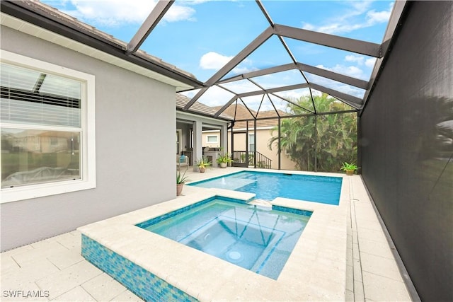 view of swimming pool with an in ground hot tub, a patio area, and glass enclosure