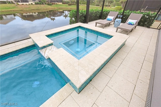 view of swimming pool featuring an in ground hot tub, a water view, and a patio area