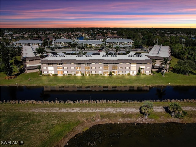 aerial view at dusk with a water view