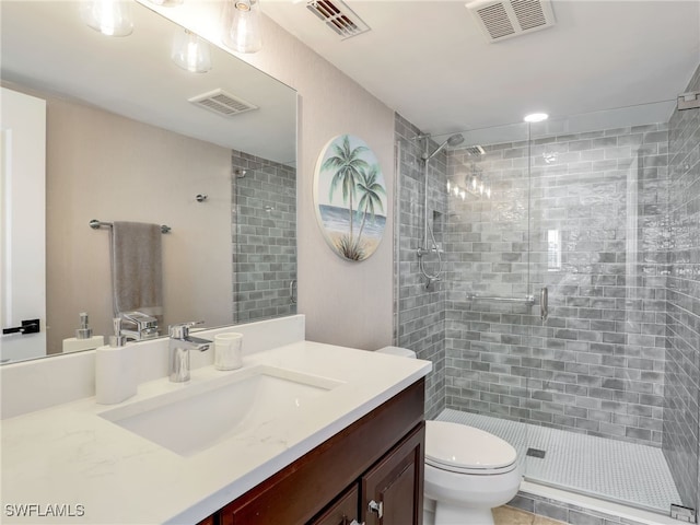 bathroom featuring toilet, an enclosed shower, and vanity