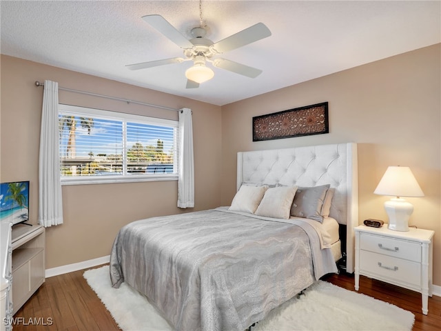 bedroom featuring ceiling fan and dark hardwood / wood-style flooring