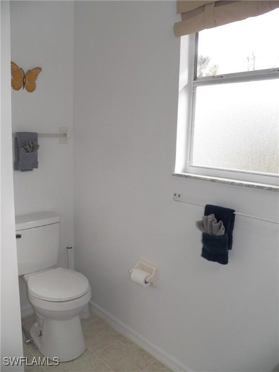 bathroom with tile patterned floors and toilet