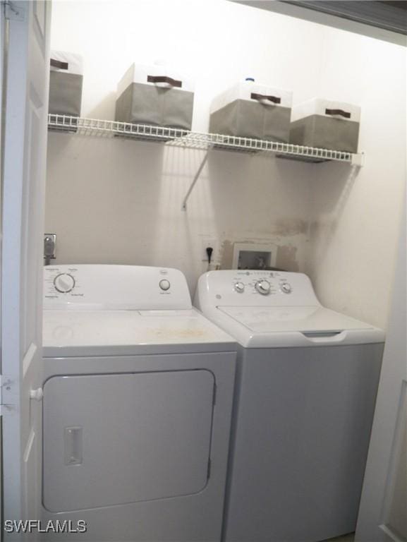 clothes washing area featuring washing machine and clothes dryer