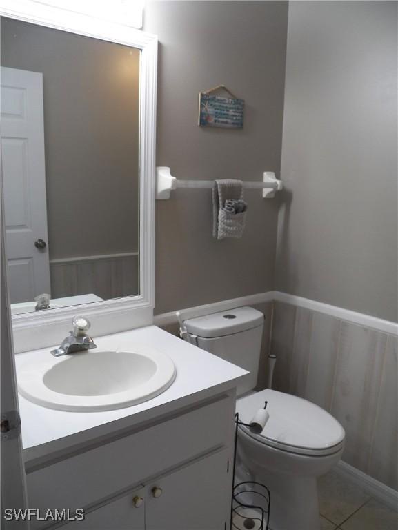 bathroom with tile patterned floors, vanity, and toilet