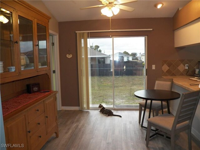 dining area with ceiling fan and light hardwood / wood-style flooring