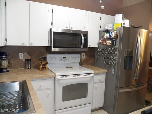 kitchen featuring white cabinetry, sink, backsplash, and stainless steel appliances