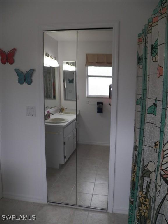 bathroom featuring tile patterned flooring and vanity