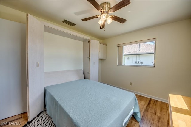 bedroom with light hardwood / wood-style flooring and ceiling fan