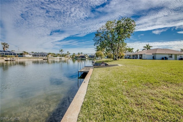 dock area with a water view and a yard