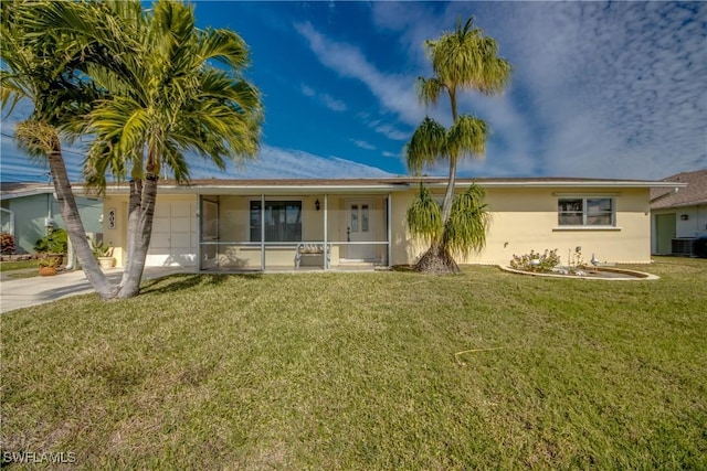 view of front of home with a sunroom, a front yard, and cooling unit