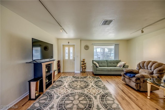 living room featuring track lighting and hardwood / wood-style floors