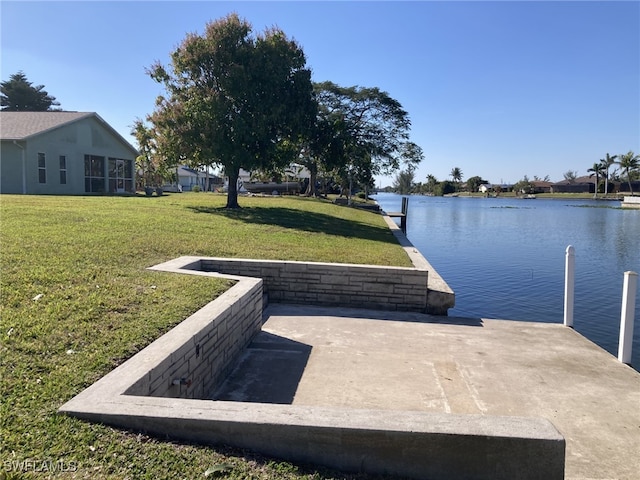 dock area with a water view and a yard