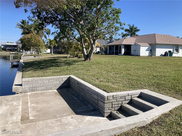 exterior space featuring a water view and a lawn