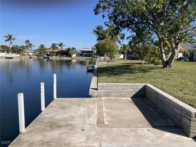 view of dock featuring a yard and a water view