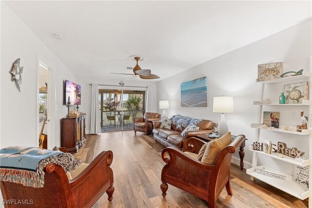 living room with ceiling fan and hardwood / wood-style floors