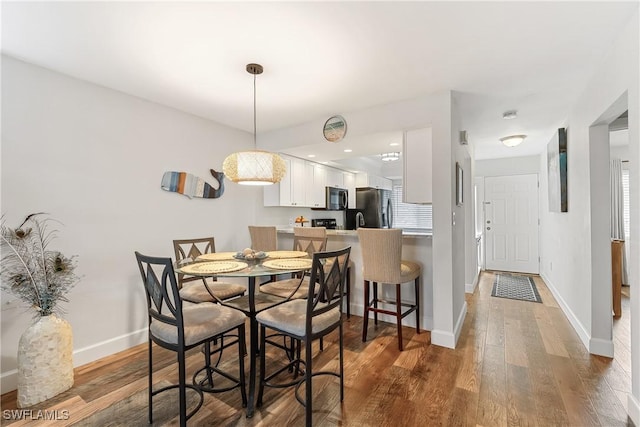 dining room with dark hardwood / wood-style floors