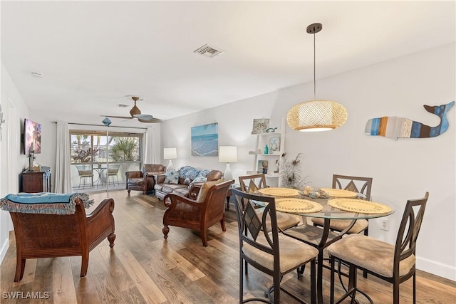 dining space with ceiling fan and wood-type flooring