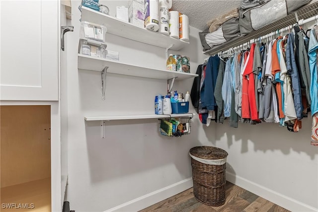 spacious closet with dark hardwood / wood-style floors