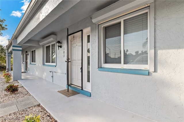 entrance to property featuring an AC wall unit