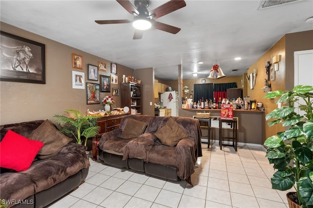 tiled living room with ceiling fan