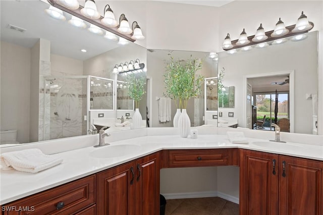 bathroom with walk in shower, vanity, tile patterned flooring, and toilet