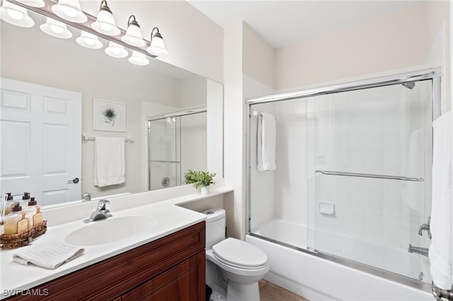 full bathroom featuring toilet, vanity, and shower / bath combination with glass door