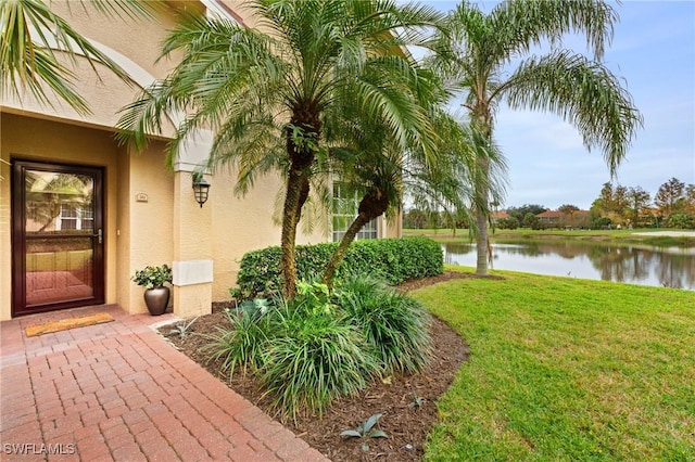 exterior space with a water view and a yard