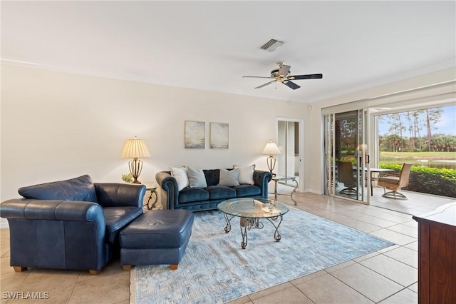 living room with ceiling fan, light tile patterned floors, and crown molding