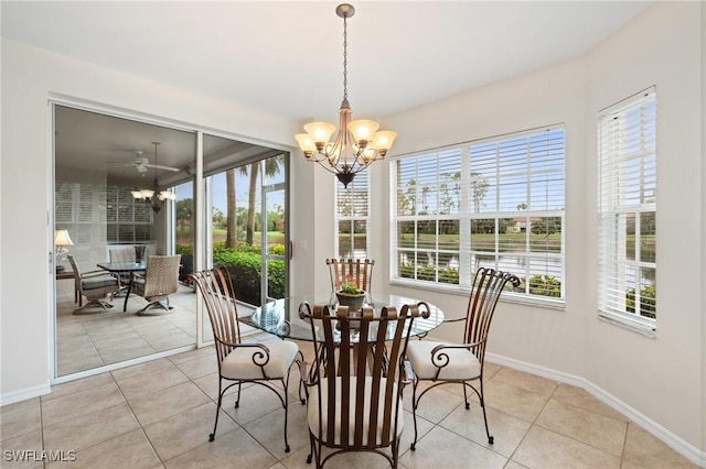 dining room featuring light tile patterned floors, plenty of natural light, and ceiling fan with notable chandelier