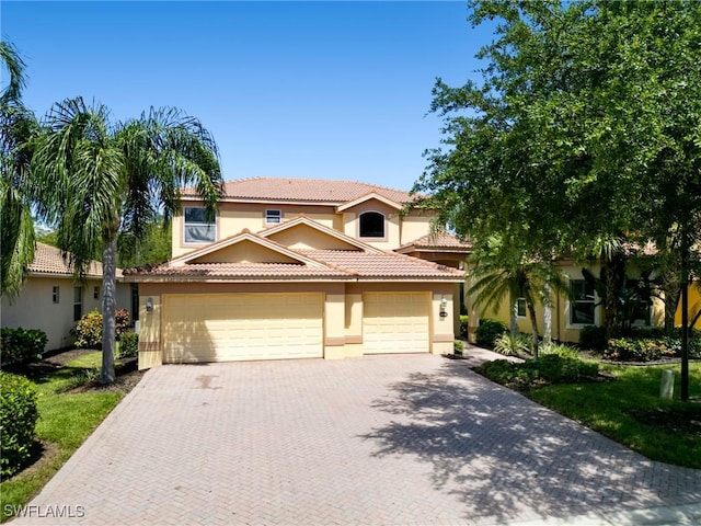 mediterranean / spanish-style house with a garage