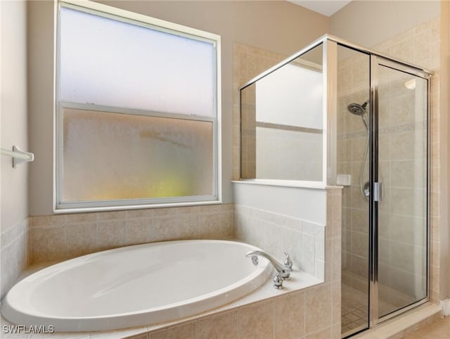 bathroom with separate shower and tub