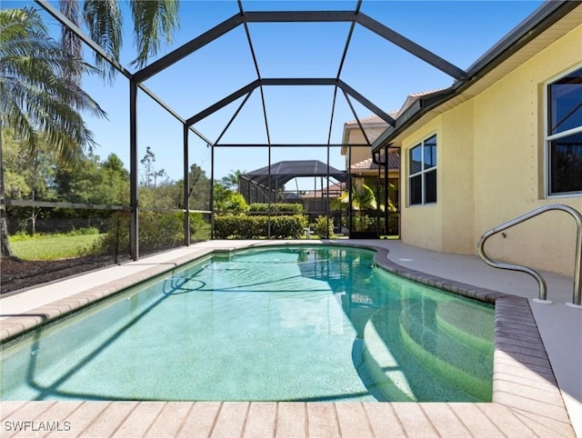 view of pool with glass enclosure