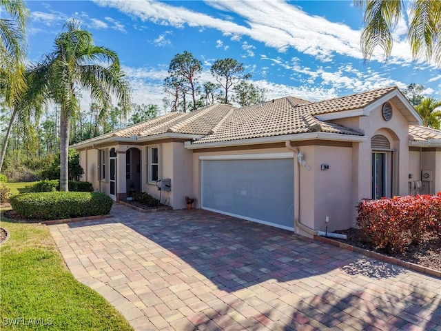 mediterranean / spanish-style home featuring a garage