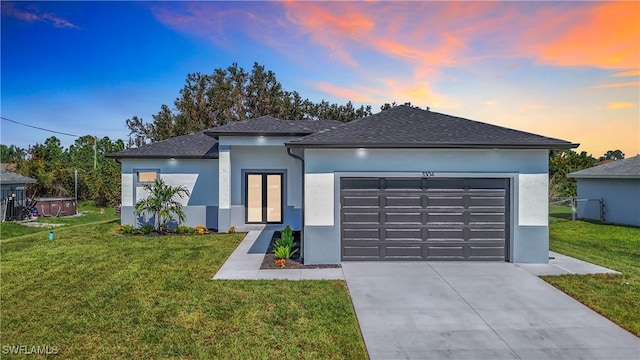 view of front of house with a lawn and a garage