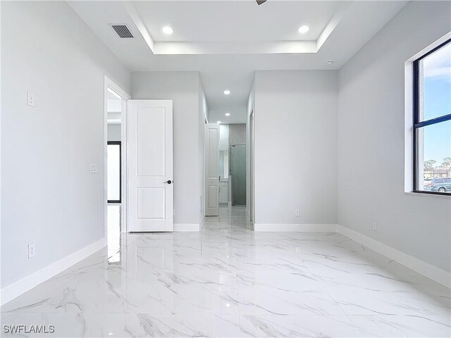 empty room featuring a raised ceiling