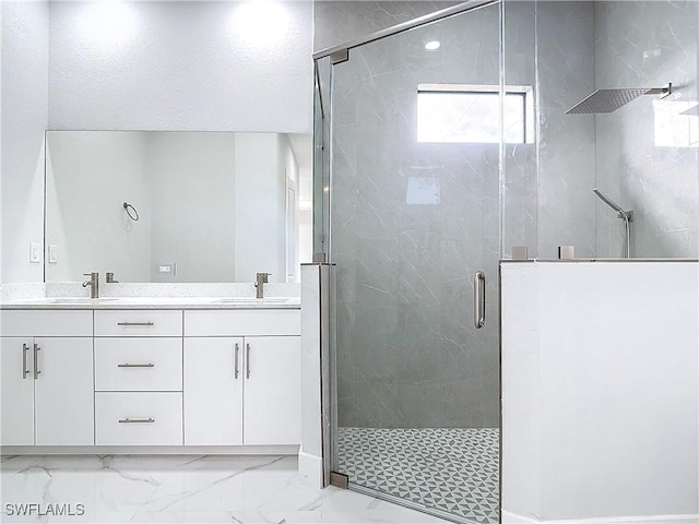 bathroom featuring vanity and a shower with shower door