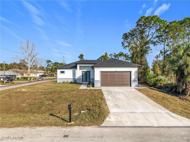 view of front of house featuring a garage and a front yard