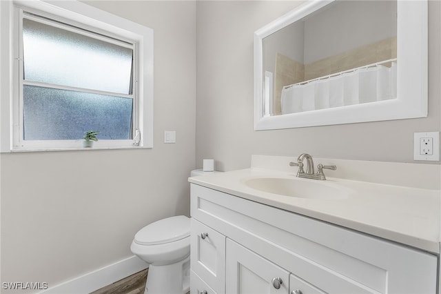 bathroom featuring toilet, a shower with curtain, and vanity