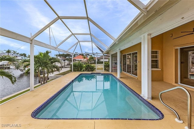 view of swimming pool featuring a patio area and glass enclosure