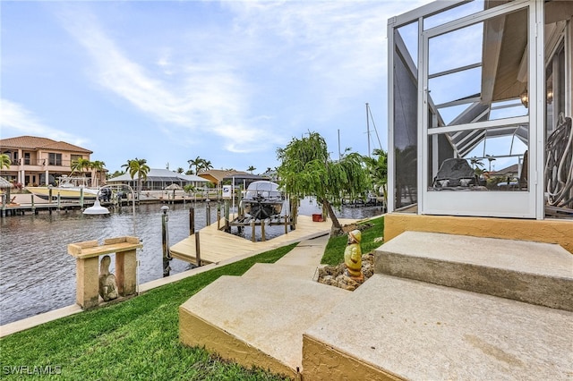 view of dock with glass enclosure and a water view