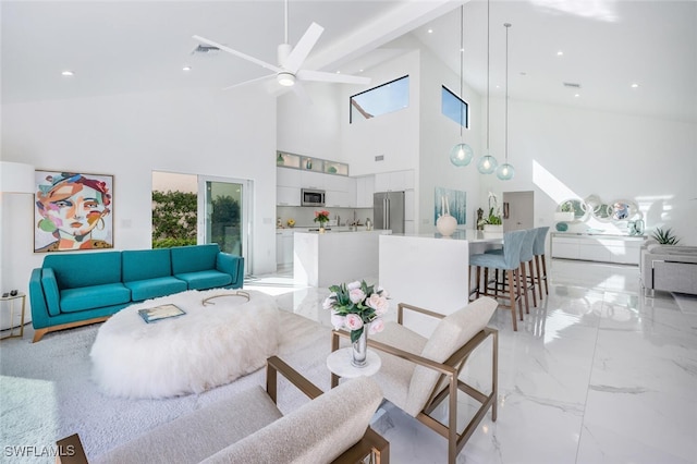 living room featuring a high ceiling and ceiling fan