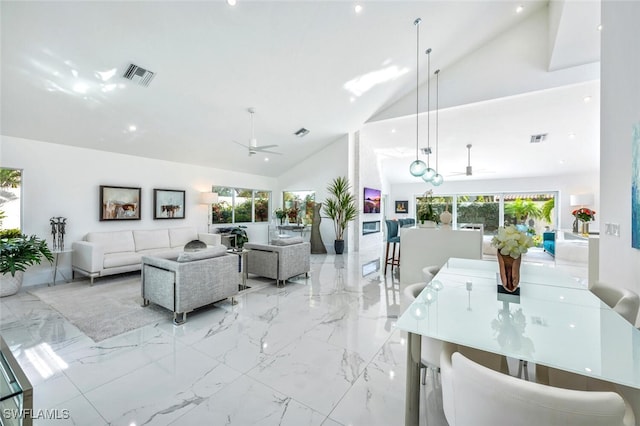 living room featuring ceiling fan, high vaulted ceiling, and a wealth of natural light