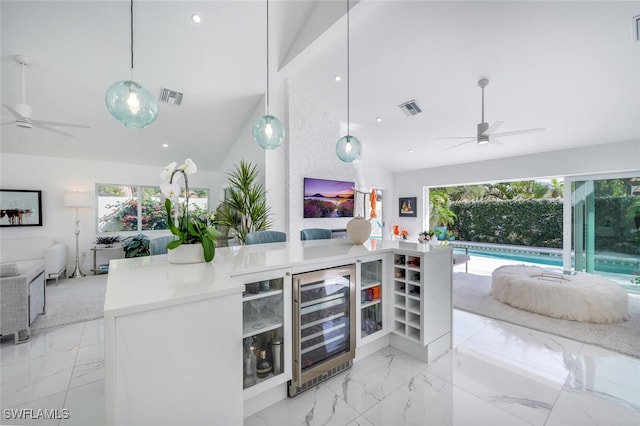 bar with ceiling fan, beverage cooler, and hanging light fixtures