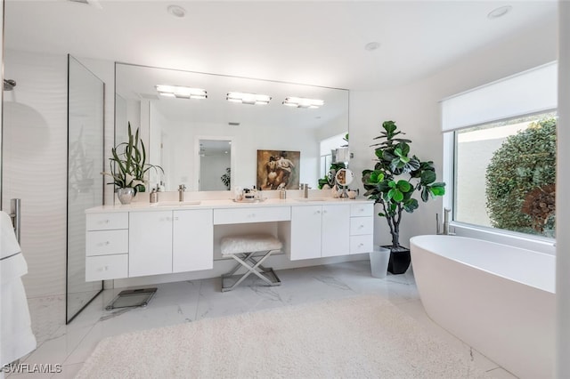 bathroom featuring vanity and a bath