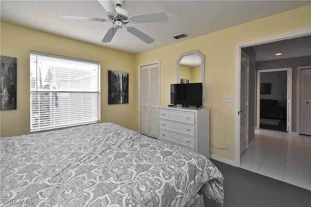 bedroom with ceiling fan, a closet, and tile patterned floors