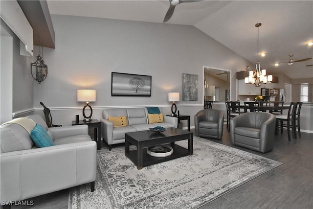 living room featuring ceiling fan with notable chandelier and lofted ceiling