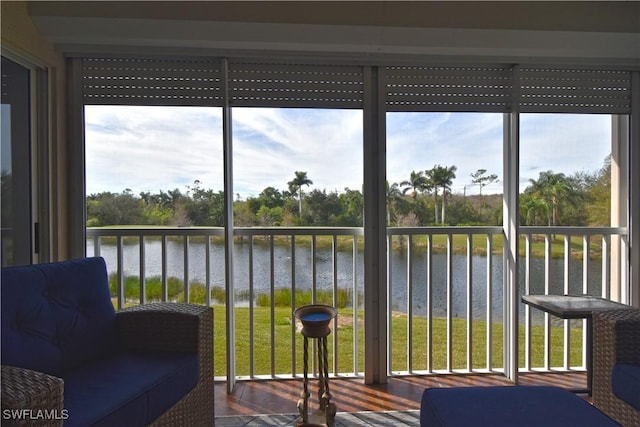 unfurnished sunroom featuring a water view